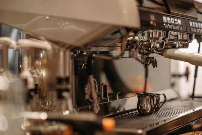 Close-up of a professional espresso machine with frothing pitcher, perfect for coffee lovers.
