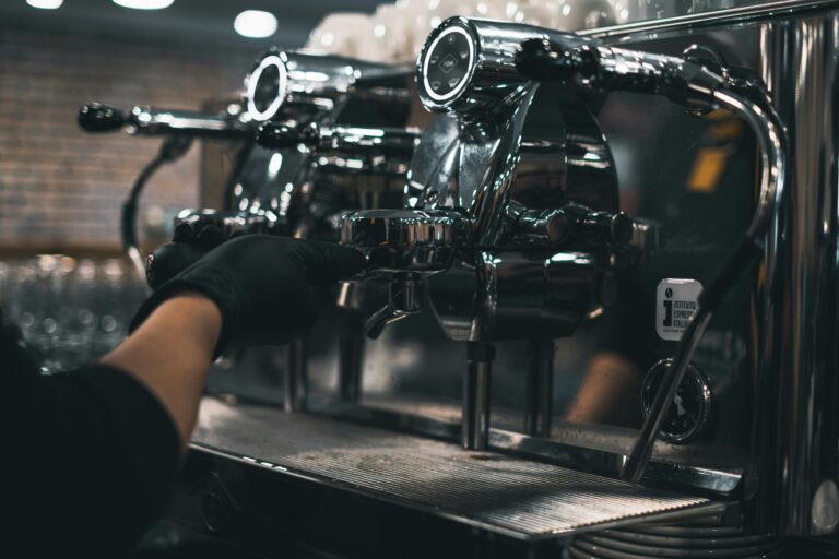 Close-up of a barista using an espresso machine at a café, capturing the essence of coffee making.